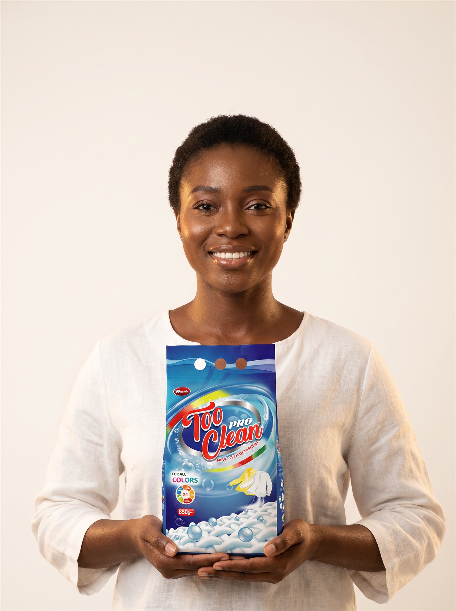 A smiling Nigerian woman holding a Too Clean Pro detergent pack